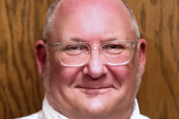 man yellow button-up shirt, wearing glasses