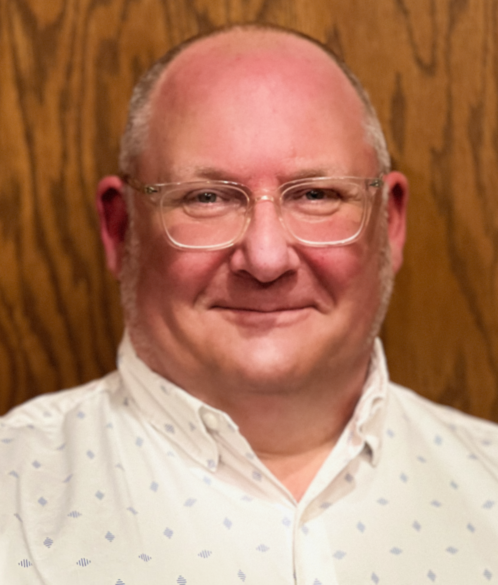 man wearing glasses and a yellow button-up shirt